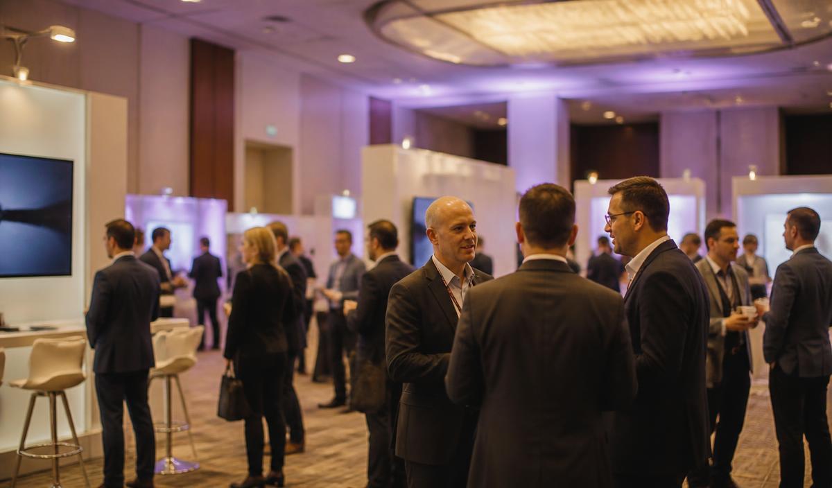 Professionals networking in a B2B conference expo hall